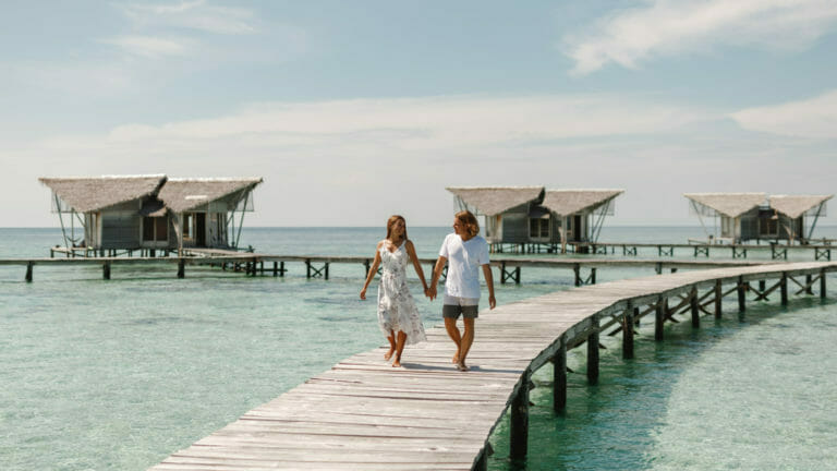 couple at overwater bungalows